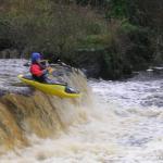 Photo of the Ennistymon Falls in County Clare Ireland. Pictures of Irish whitewater kayaking and canoeing. Eoin O'R on one of the drops. Photo by Tiernan